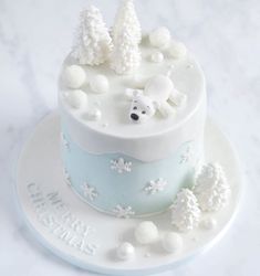 a cake decorated with white frosting and decorations