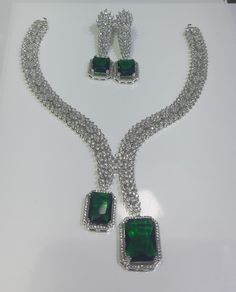 Faux CZ Diamonds Green Necklace Earrings Set, Bridal Dangler Earrings, Bridal Choker, Party Wear Emerald Necklace Earrings, Statement Piece ITEM DESCRIPTION Metal        = Silver Plated Occasion  = Wedding, Party Wear, Bridal Color        = White and Green Size          = Necklace Length = 7 Inches Long, Earring Size = 22 Inches Long,  Free Shipping 100% Satisfaction Guarantee: 1 Year Warranty, Long Lasting Plating, High-Quality Stones Occasion: Perfect choice for any Indian occasion.  Care: It Party Jewelry Sets With Matching Dangle Earrings, Party Crystal Jewelry With Matching Earrings, Cubic Zirconia Dangle Jewelry Sets For Party, Party Jewelry Sets With Dangle Sparkling Stones, Dangle Jewelry Sets With Sparkling Stones For Party, Cubic Zirconia Costume Bridal Necklace For Parties, Cubic Zirconia Dangle Bridal Necklace For Party, Sparkling Stone Dangle Jewelry Sets For Party, Green Sparkling Stones Jewelry Sets For Party