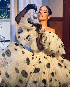 a woman in a white dress with black polka dots