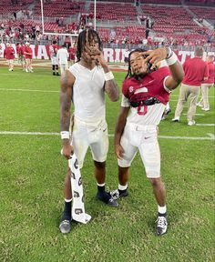 two football players are standing on the field