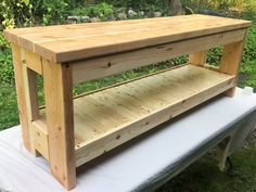 a wooden bench sitting on top of a white sheet