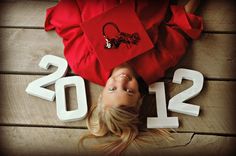 a woman laying on the floor next to numbers that spell out 2012 and two bags