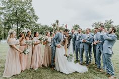 a group of people standing next to each other on top of a lush green field