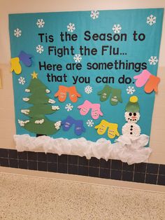 a bulletin board with snowmen and christmas trees on the wall in a classroom setting