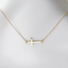 14K gold sideways cross necklace 14K gold sideways cross is about 19mm x 8mm 14K gold 1 mm diamond-cut cable chain All components are 14k gold 14k Gold Cross Necklace With Adjustable Chain, Gold Cross Pendant With Cable Chain, Gold Cross Pendant Jewelry With Cable Chain, Gold Cross Pendant Cable Chain Jewelry, Gold Jewelry With Cable Chain Cross Pendant, Minimalist Crucifix Jewelry With Adjustable Chain, Minimalist 14k Gold Crucifix Jewelry, 14k Gold Delicate Chain Cross Necklace, Sideways Cross Necklace