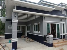 a house under construction with blue and gray paint on the walls, windows and doors