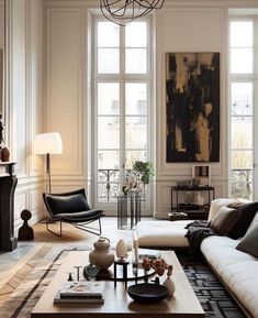 a living room filled with lots of furniture next to tall windows and a fire place