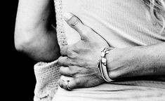 black and white photograph of woman's hands with bracelet