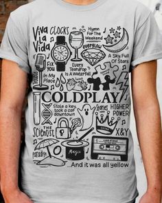 a man standing in front of a brick wall wearing a t - shirt that says coldplay and it was all yellow