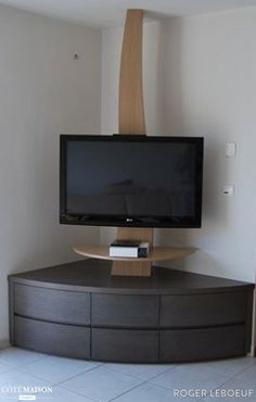 a flat screen tv sitting on top of a wooden stand