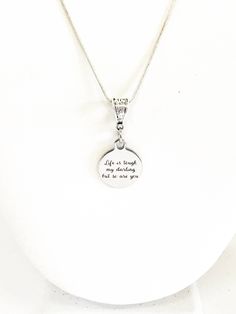 "This is a stainlses steel laser engraved pendant on a sterling silver plated chain. The pendant has \"Life is tough my darling but so are you\" on it. This pendant is available on your choice of 16, 18, 20, 22, 24, 26, 28 or 30 inch sterling silver chain. The pendant is also available for individual purchase if you have another chain on which you would like to wear it. This jewelry item has small parts and is not intended for anyone under the age of 14. To see the latest items and specials, fol Meaningful Engraved Charm Necklaces With Round Pendant, Meaningful Silver Pendant Charm Necklace, Inspirational Sterling Silver Charm Necklace With Round Pendant, Meaningful Engraved Charm Necklace For Best Friend, Inspirational Engraved Silver Charm Necklace, Inspirational Silver Charm Necklace With Round Pendant, Inspirational Engraved Sterling Silver Charm Necklaces, Engraved Meaningful Charm Necklace For Best Friend, Inspirational Sterling Silver Pendant Necklace