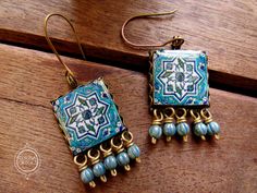 Dreaming of hand tiled Islamic Mosques? These earrings are grand handmade reproductions of beautiful Islamic tiles. A larger tile for a bolder statement. Ready to ship in crafty packaging. The handmade tile measures 2cm by 2cm square, and sits in an antique bronze lace edge setting. Beautiful frosty turquoise melon beads dangle in delight! The drop length of the earring is approximately 5.6 cm ensuring the earring will not go unnoticed! I recreate and hand make vintage Islamic tile patterns in m Handmade Bohemian Square Earrings, Handmade Square Bohemian Earrings, Handmade Square Turquoise Jewelry, Islamic Pottery, Tile Jewelry, Islamic Tiles, Pottery Design, Turkish Tile, Handmade Tile