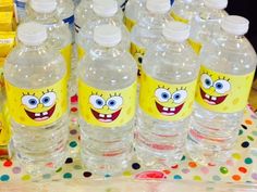 several bottles of water with cartoon faces on them