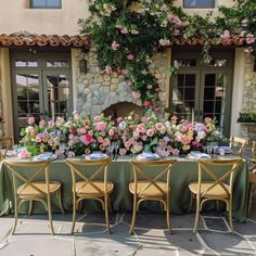 the table is set with flowers and place settings for four people to sit at it