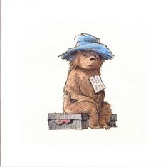 a card with a drawing of a bear wearing a blue hat and holding a piece of paper