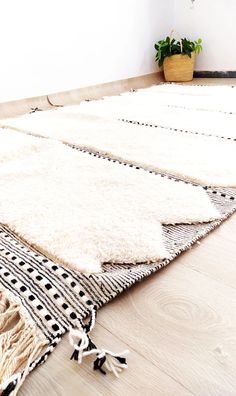 a white rug with black and white designs on it in the middle of a room