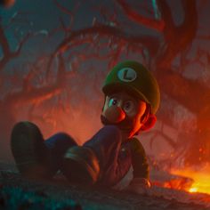 luigi in mario's mushroom hat sitting on the ground next to a burning tree