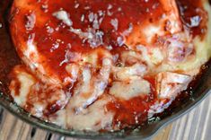 a pan filled with sauce on top of a wooden table