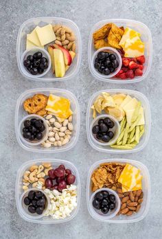 six plastic containers filled with different types of snacks and nuts, including apples, grapes, bananas