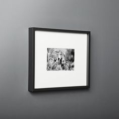 a black and white photo hanging on the wall