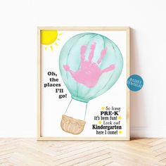 a framed poster with a handprinted hot air balloon in the sky on it