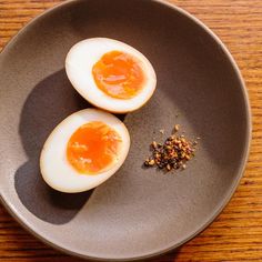 two hard boiled eggs on a plate with seasoning