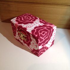 a pink and white box sitting on top of a table