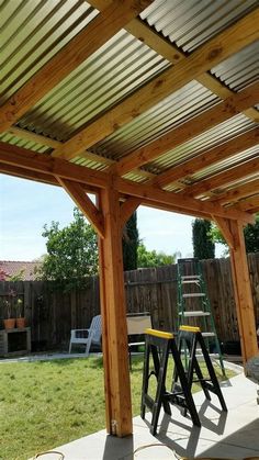 an outdoor patio area with two stools and a ladder