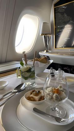 the interior of an airplane with food and drinks