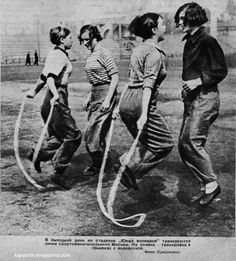 an old black and white photo of four young people with hoses in their hands