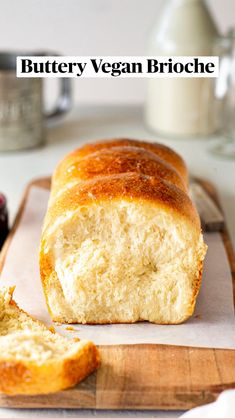 a loaf of buttery vegan brioche on a cutting board next to some berries