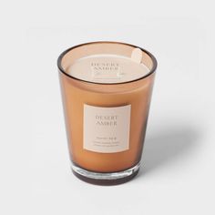 a candle that is sitting on top of a white surface with the words, essere