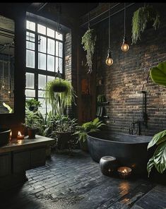 a bath tub sitting in the middle of a bathroom next to a window with plants on it