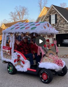 two people riding in a toy car decorated with christmas decorations