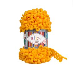 a jar filled with yellow yarn on top of a white surface and the words alize written