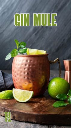 a copper mug with limes and mint garnish