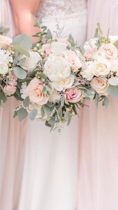 the bridesmaids are holding their bouquets with pink and white flowers on them