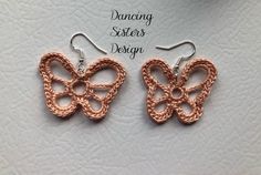 two pairs of crocheted butterfly earrings with dangling hooks in pink and silver, on a white background