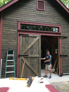 a man standing in the doorway of a barn