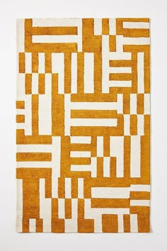 an orange and white area rug on a white surface with lines drawn across the pattern