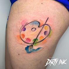 a woman's thigh with an artistic tattoo on it