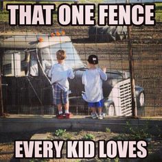 two young boys standing next to each other in front of a fence with an old truck behind them