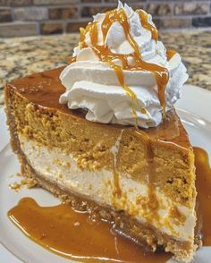 a slice of pumpkin cheesecake with whipped cream and caramel drizzle on top