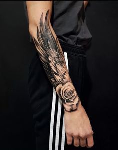 a man's arm with a rose and an angel tattoo on his left arm