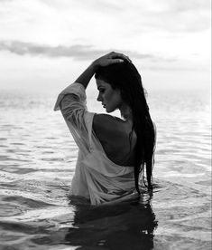 black and white photo of woman in water with long hair looking off to the side