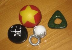 three different types of toys sitting on a table next to each other, including a ball and ring