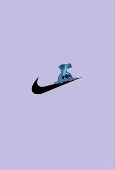 a blue and black nike shoe with a skull on it's head in the air