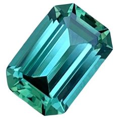 an emerald colored diamond on a white background