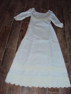 "Beautiful White Modest Linen And Venetian Lace Bridal Gown Size XS- S Excellent Vintage Condition, No Rips Or Tears, A Few Light Stains On The Bottom Inside Lining Of Train Fully Lined Empire Waist Dress Elbow Length Sleeves Rounded Boat Neckline Back Metal White Zipper (Zips Fine Too Small For My Dress Form) 6\" X 1.75\" White Bow Attached In Back Several Rows Of 3-5\" Venetian Lace Lace Is Slightly Differnt Shade Of White Very Fitted Bodice With Darts And Venetian Lace Around Empire Waist A L Regency Style Empire Waist Wedding Gown, Regency Style Wedding Gown With Fitted Bodice, Victorian White Ball Gown Dress, White Victorian Ball Gown Dresses, Victorian White Ball Gown, Regency Style White Victorian Dress For Debutante Ball, White Regency Victorian Dress For Debutante Ball, White Regency Style Victorian Dress For Debutante Ball, White Victorian Empire Waist Dress