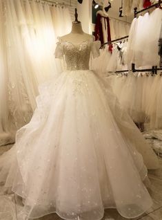 a white wedding dress on display in a store